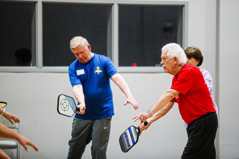 Pickleball instructor Don Gary, right, works with students during the Pickleball Play and Lessons for Seniors class on Thursday, March 28, 2024, at Peace Tree United Methodist Church in Collierville, Tenn. Gary, a retired dentist, has taught pickleball in Collierville since 2018.