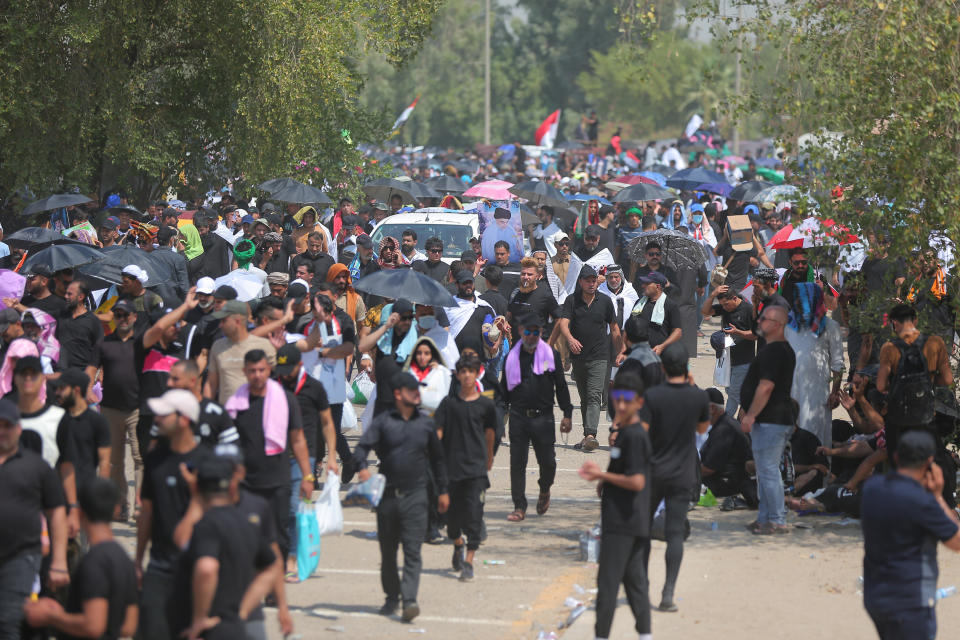 Followers of Shiite cleric Muqtada al-Sadr gather during an open-air Friday prayers at Grand Festivities Square within the Green Zone, in Baghdad, Iraq, Friday, Aug. 5, 2022. (AP Photo/Anmar Khalil)