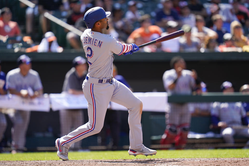 Texas Rangers' Marcus Semien watches his ball while hitting a solo home run against the Baltimore Orioles during the ninth inning of a baseball game, Monday, July 4, 2022, in Baltimore. The Orioles won 7-6 in ten innings. (AP Photo/Julio Cortez)