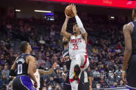 Houston Rockets center Christian Wood (35) shoots over Sacramento Kings guard Tyrese Haliburton (0) during the first quarter of an NBA basketball game in Sacramento, Calif., Friday, Jan. 14, 2022. (AP Photo/Randall Benton)