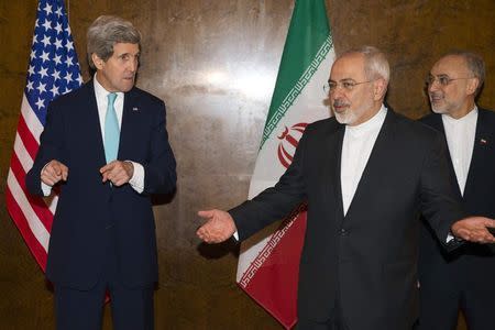 U.S. Secretary of State John Kerry and Iran's Foreign Minister Mohammad Jawad Zarif (C) gesture as they arrive to resume nuclear negotiations in Montreux March 2, 2015. REUTERS/Evan Vucci/Pool