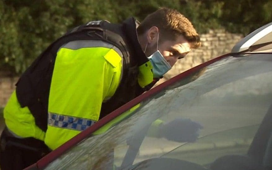 A North Yorkshire Police officer talks to a driver on the border with West Yorkshire, which is in Tier 3