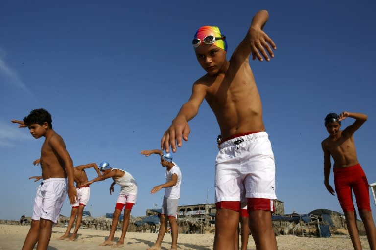 Young members of a Palestinian swimming club excercise on a beach during a training session in Beit Lahia in the northern Gaza Strip, on October 4, 2018