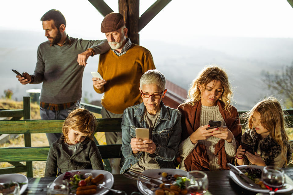 People on their phones at the dinner table