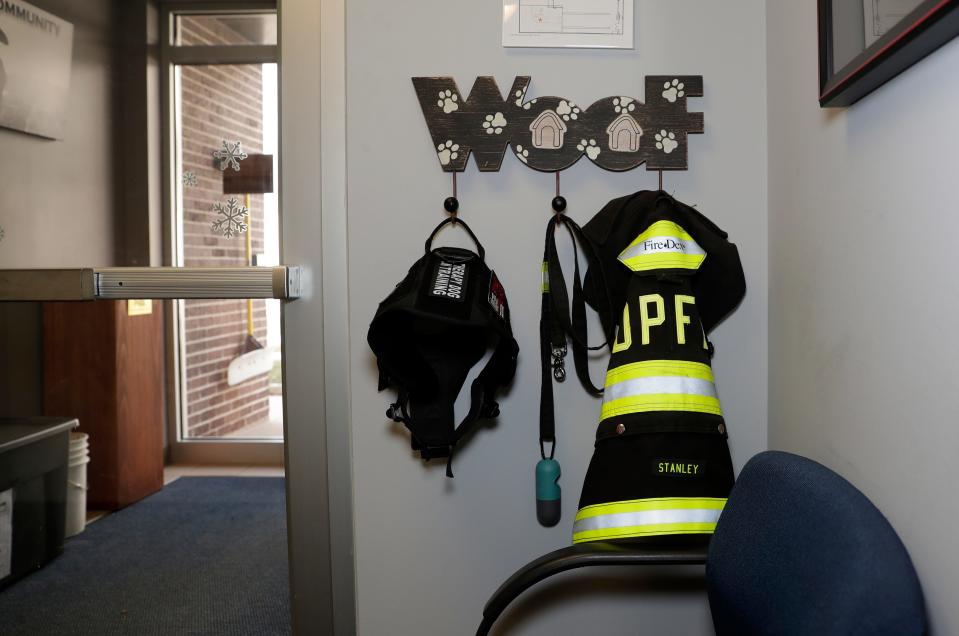 Stanley's "therapy dog in training" vest and fire coat hang on a canine coat rack at De Pere Fire Rescue. He officially passed his therapy dog training on Feb. 15.