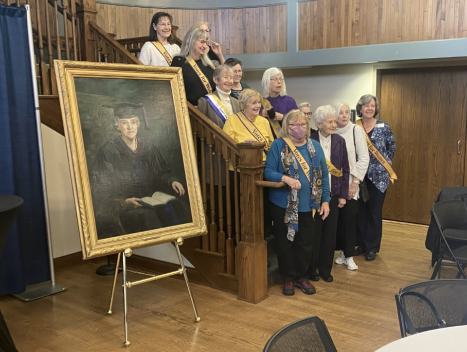 Members of the Leage of Women Voters of Columbia-Boone County on Thursday, Jan. 19, 2023, pose next to a portrait of Luella St. Clair - Moss in Dorsey Hall at Columbia College on Charter Day at the College.  The league is lobbying to have the next elementary school in Columbia Public Schools named for St. Clair-Moss.