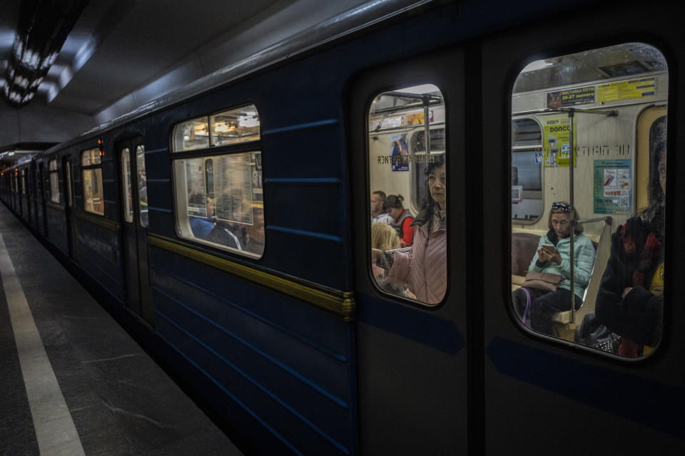 Commuters take the subway in Kharkiv, eastern Ukraine, Tuesday, May 24, 2022. Kharkiv subway resumed service on Tuesday morning after it was closed for more than two months during Russian attempt to capture the city. (AP Photo/Bernat Armangue)