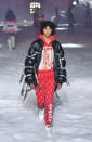 <p>Model wears a red “Playboy”-branded sweatshirt and trousers with black puffer jacket at the Philipp Plein FW18 show. (Photo: Getty) </p>