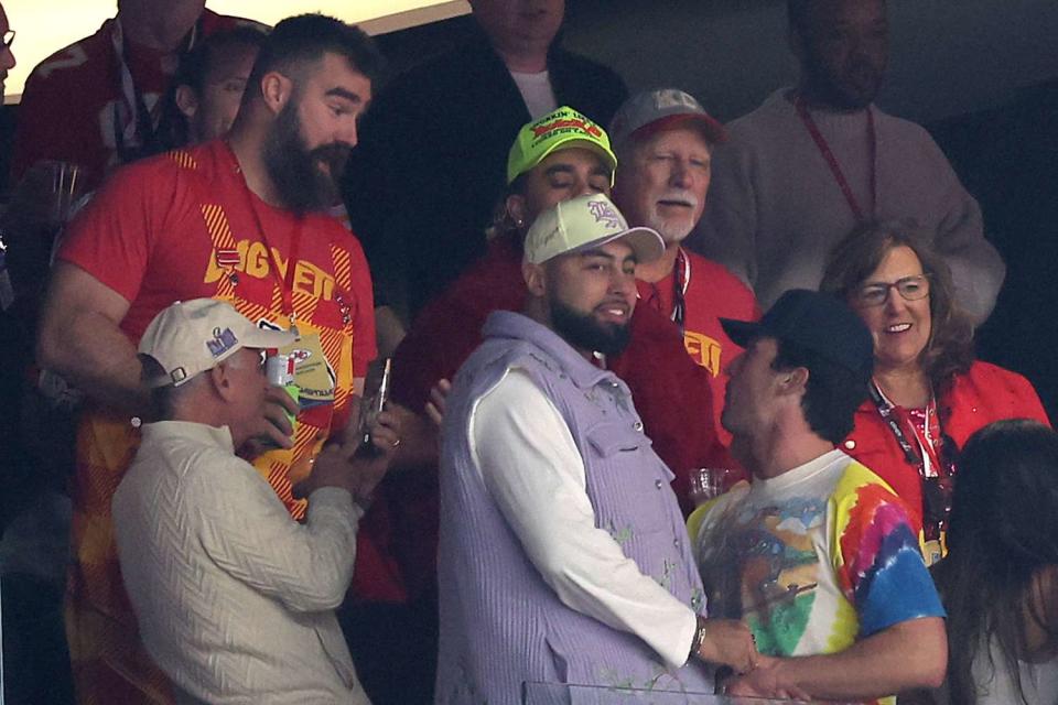 <p>Steph Chambers/Getty</p> Jason Kelce talks to Miles Teller at the Super Bowl in Las Vegas on Feb. 11, 2024