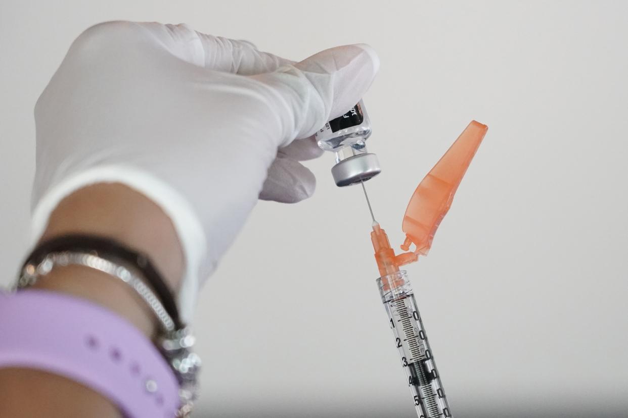 A nurse loads a syringe with the Pfizer COVID-19 vaccine, in Jackson, Miss, Tuesday, Sept. 21, 2021. 