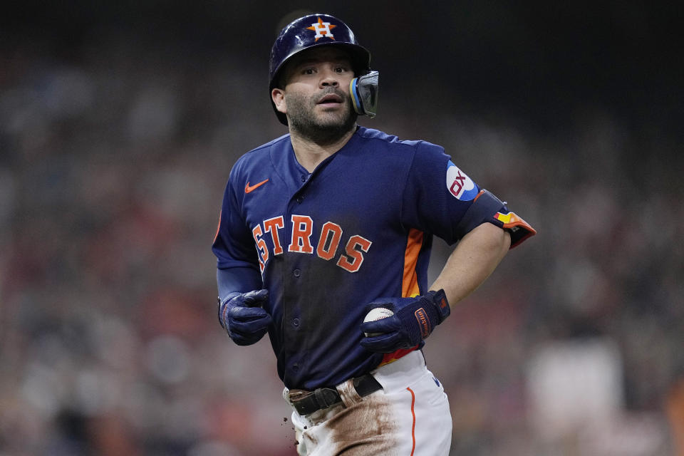 Houston Astros' Jose Altuve returns to the dugout after his 2,000th career hit during the fifth inning of a baseball game against the Seattle Mariners, Saturday, Aug. 19, 2023, in Houston. (AP Photo/Kevin M. Cox)