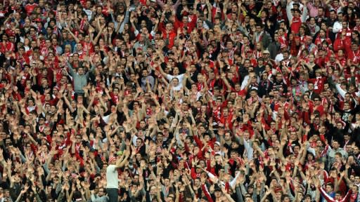 It could be a long time before supporters like these Bayern Munich fans can gather in stadiums again