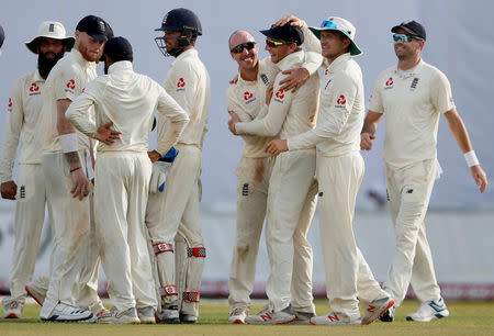 Cricket-England v Sri Lanka, First Test - Galle, Sri Lanka - November 7, 2018. England's Jack Leach (C) celebrates with Jos Buttler (3rd R) and his teammates after taking the wicket of Sri Lanka's Dilruwan Perera (not pictured). REUTERS/Dinuka Liyanawatte