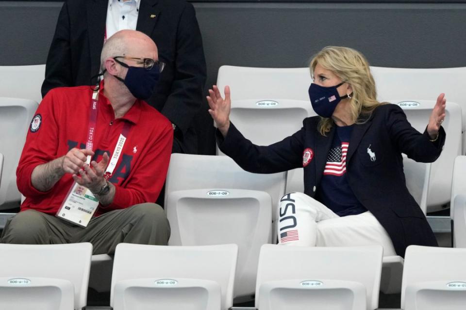 First Lady of the United States Jill Biden, right, gestures as she talks to Raymond Greene prior to the start of the swimming competition at the 2020 Summer Olympics, Saturday, July 24, 2021, in Tokyo, Japan. - Credit: AP