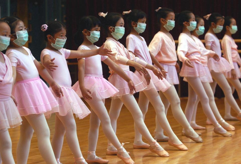 Children attend ballet lessons wearing masks to protect themselves from severe acute respiratory syndrome, SARS, in Hong Kong Sunday April 27, 2003.