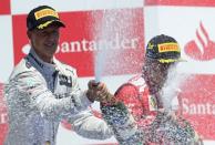 Ferrari's Spanish driver Fernando Alonso (R) and Mercedes' German driver Michael Schumacher celebrate on the podium at the Valencia Street Circuit in Valencia after the European Formula One Grand Prix