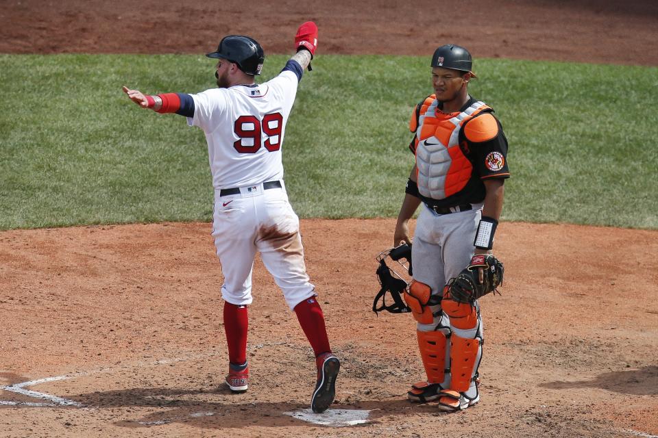 Boston Red Sox's Alex Verdugo (99) scores in front of Baltimore Orioles' Pedro Severino on a single by Red Sox's Kevin Plawecki during the sixth inning of a baseball game Saturday, July 25, 2020, in Boston. (AP Photo/Michael Dwyer)