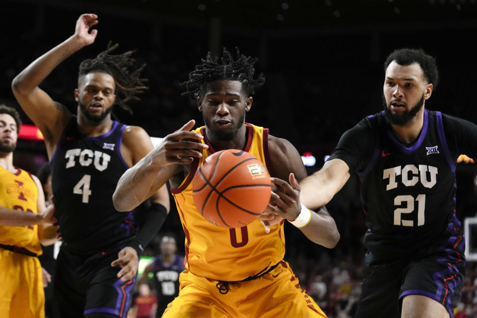 Iowa State forward Tre King (0) fights for a loose ball with TCU center Eddie Lampkin Jr. (4) and forward JaKobe Coles (21) during the second half of an NCAA college basketball game, Wednesday, Feb. 15, 2023, in Ames, Iowa. (AP Photo/Charlie Neibergall)