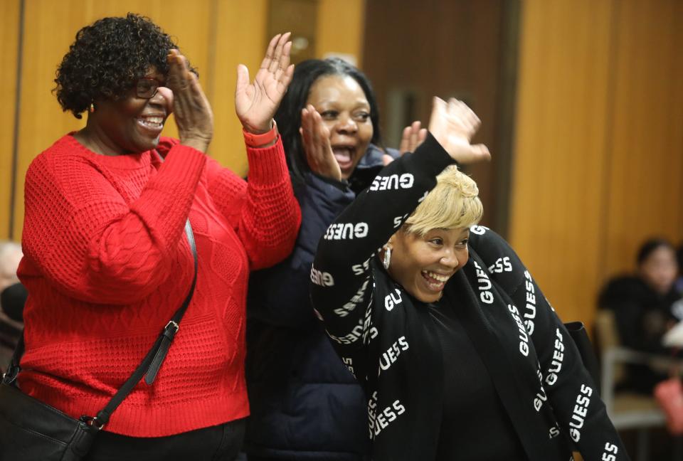 Michael Rhynes's sisters, Petronia and Linda Rhynes and daughter, Michelle Miller, wave as he gets off the elevator. Rhynes was in court to have his charges formally dismissed from his 1984 arrest and wrongful double murder conviction that sent him to prison for 37 years.