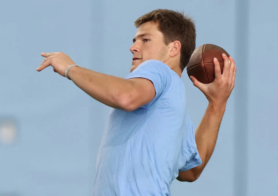 Drake Maye drops back to pass to a receiver during the Carolina Football Pro Day at UNC Chapel Hillu2019s Koman Indoor Practice Facility on Thursday, March 28, 2024.