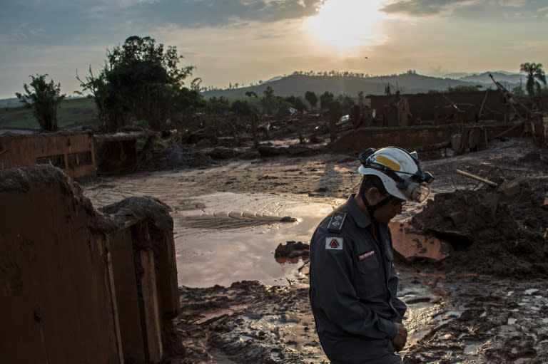 A firefighter walks in the mud in Bento Rodrigues, three days after an avalanche of mud and mining sludge buried the town in southeastern Brazil, on November 8, 2015