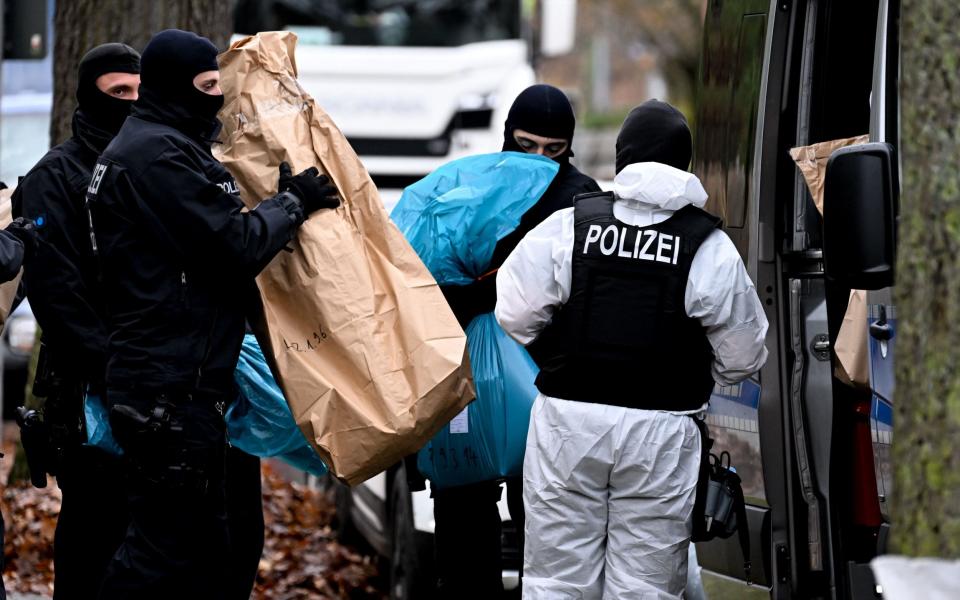 Police carry bags to their van - Filip Singer/EPA-EFE/Shutterstock