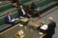 In this handout photo provided by UK Parliament, Britain's Prime Minister Boris Johnson, right, speaks during Prime Minister's Questions, as members of parliament observe social distancing due to the coronavirus, in the House of Commons, London, Wednesday, May 6, 2020. (Jessica Taylor/UK Parliament via AP)