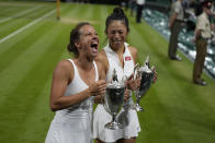 Barbora Strycova of the Czech Republic, left, and Taiwan's Hsieh Su-Wei celebrate with their trophies after beating Australia's Storm Hunter and Belgium's Elise Mertens to win the final of the women's doubles on day fourteen of the Wimbledon tennis championships in London, Sunday, July 16, 2023. (AP Photo/Alastair Grant)