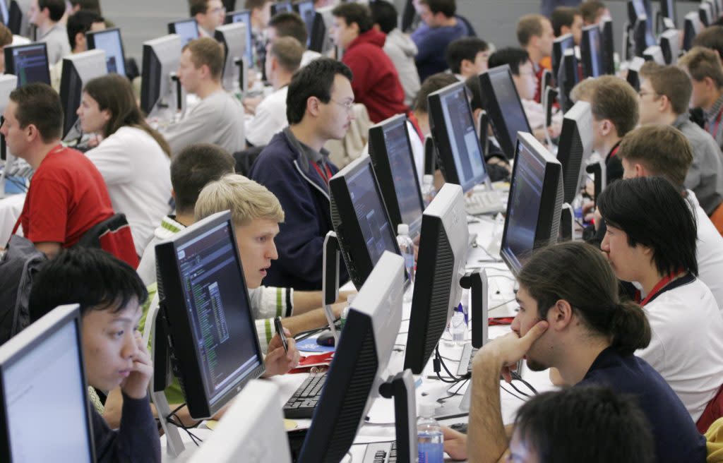 Contestants in the 2006 Google Global Code Jam stare at their computer screens at Google's New York office Friday, Oct. 27, 2006. One hundred of the best computer coders from around the world compete for prize money and bragging rights. The finalists from 20 countries are flown to New York by Google for the competition. (AP Photo/Mark Lennihan)