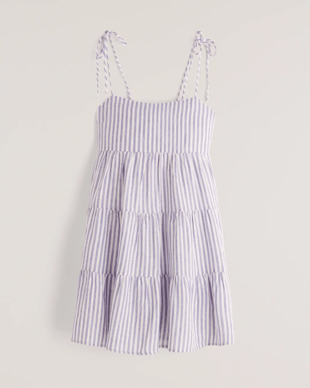 <p><strong>Abercrombie & Fitch Tie-strap Tiered Mini Dress in White Stripe, $69, <a href="https://rstyle.me/+OIkEQKCfZPEzqGrMAdvOOg" rel="nofollow noopener" target="_blank" data-ylk="slk:available here;elm:context_link;itc:0;sec:content-canvas" class="link ">available here</a> (sizes XXS-XL):</strong> "If you had told me in 2021 I love Abercrombie's simple dresses for just throwing into my bag and going, I would not believe you, but here we are. I especially love that they come in 'tall' lengths." —Liza Sokol, Senior Audience Development Manager </p>