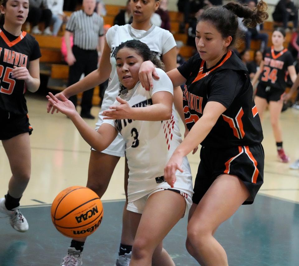 Michelle Mota of West Warwick knocks the ball loose from incoming Pawtucket guard Tiyara Gonzalez in the second quarter.