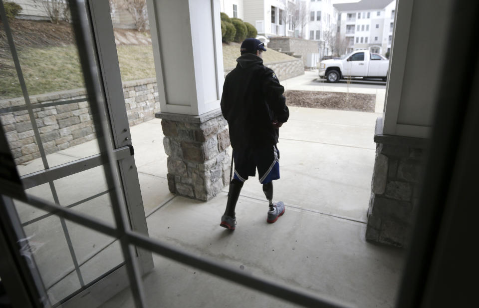 In this March 25, 2014 photo, Boston Marathon bombing survivor Marc Fucarile walks from his home in Reading, Mass. Fucarile lost his right leg in an explosion April 15, 2013, near the finish line of the race. (AP Photo/Steven Senne)