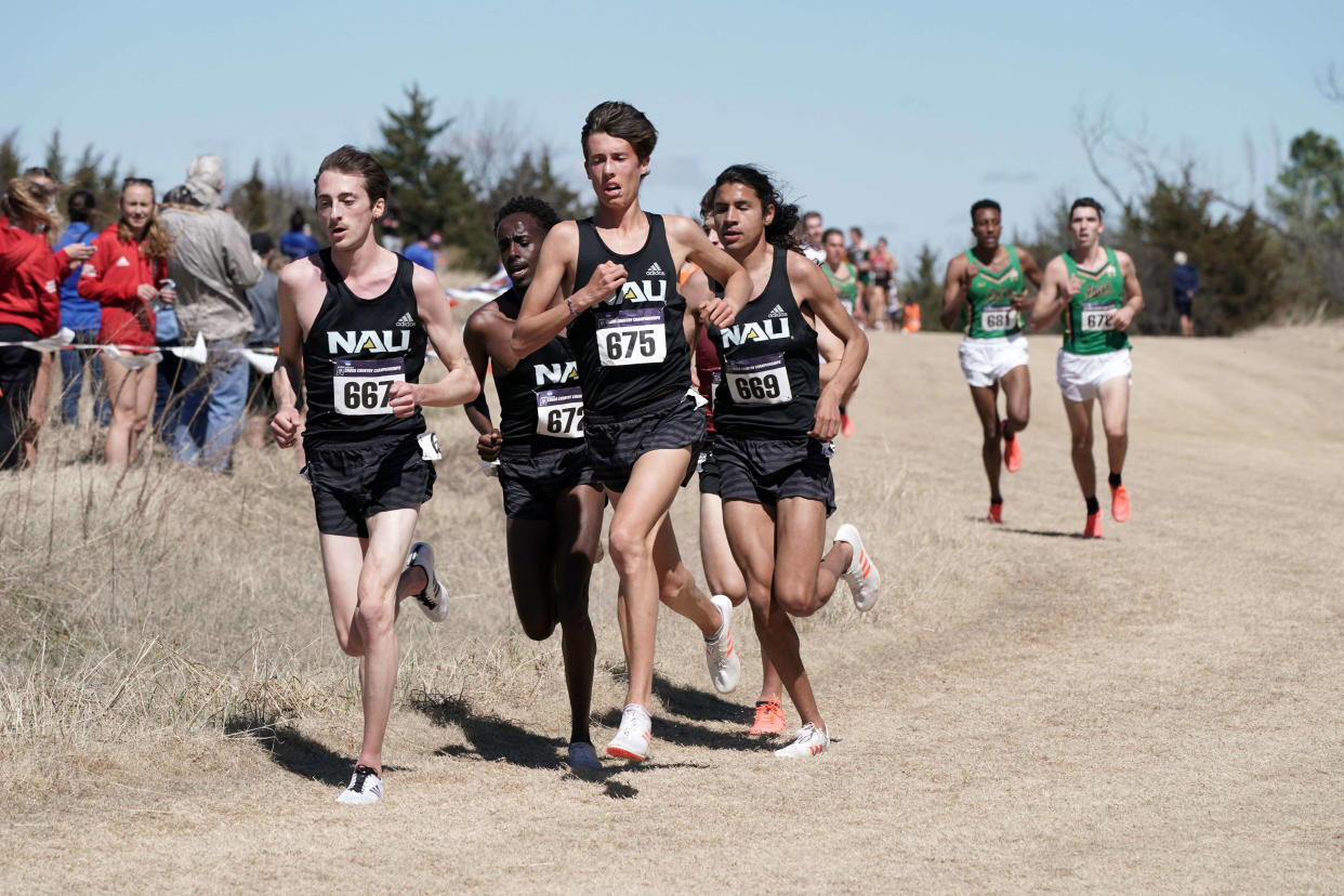 Mar 15, 2021; Stillwater, Oklahoma, USA; Blaise Ferro (667), Nico Young (675), Abdihamid Nur (672) and Luis Grijalva (669) of Northern Arizona run in the men's race  during the NCAA Cross County Championships at the OSU Cross Country Course. NAU won the team title over Notre Dame 60-87.  Mandatory Credit: Kirby Lee-USA TODAY Sports 