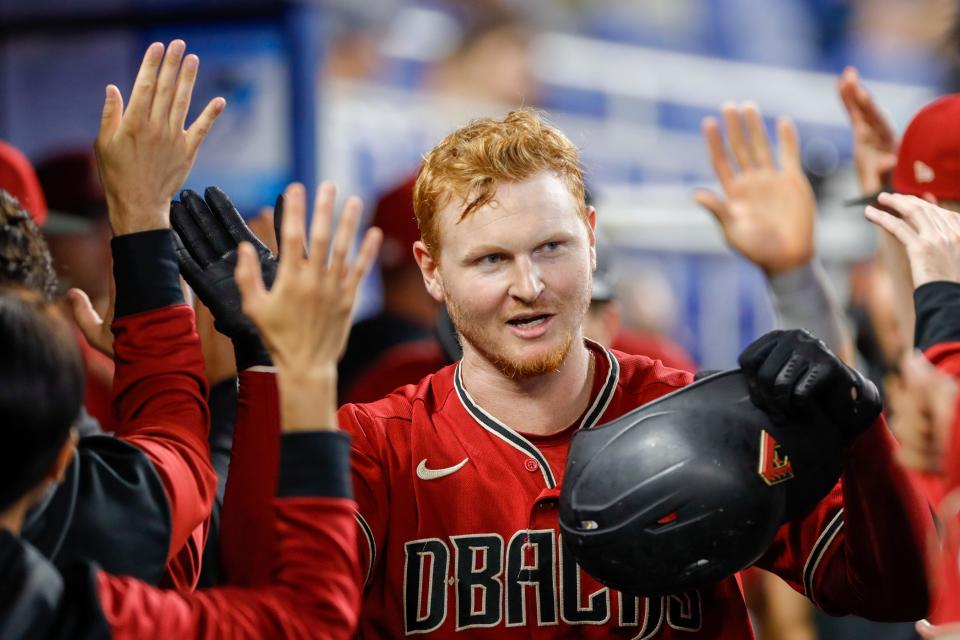 Diamondbacks right fielder Pavin Smith, a Palm Beach Gardens graduate, celebrates with teammates after hitting a two-run homer in the ninth inning against the Marlins Wednesday in Miami.