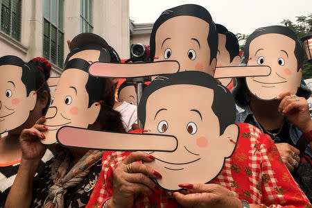 Pro-democracy activists wearing masks mock Thailand's Prime Minister Prayuth Chan-ocha as Pinocchio during a protest against junta at a university in Bangkok, Thailand, February 24, 2018. REUTERS/Panarat Thepgumpanat