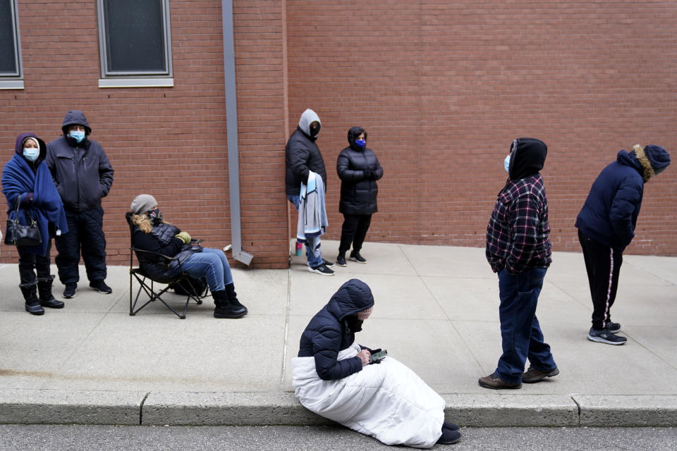 People wait in line for the COVID-19 vaccine in Paterson, N.J.,  on Jan. 21, 2021. The first people arrived around 2:30 a.m. for the chance to be vaccinated at one of the few sites that does not require an appointment. (Seth Wenig/AP)