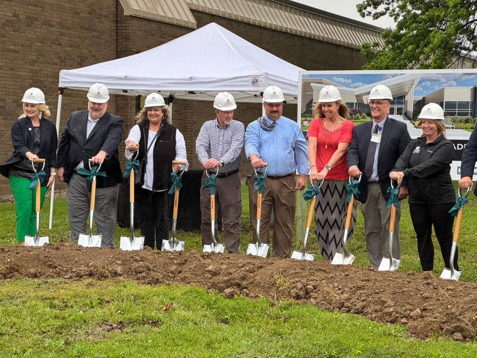 Ashland County- West Holmes Career Center Board of Education members pick up their shovels for the ceremonial groundbreaking of the renovation and new construction project.