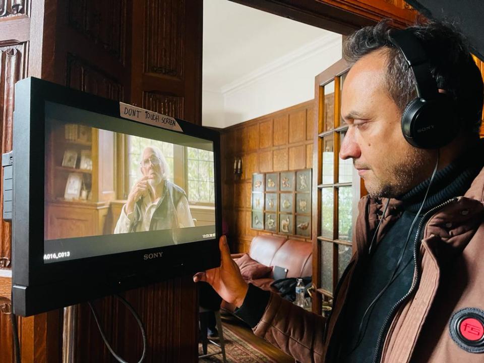 Director Binod Paudel looks at a screen showing Bruce Dern while shooting "The World's Happiest Man" on location in Akron.