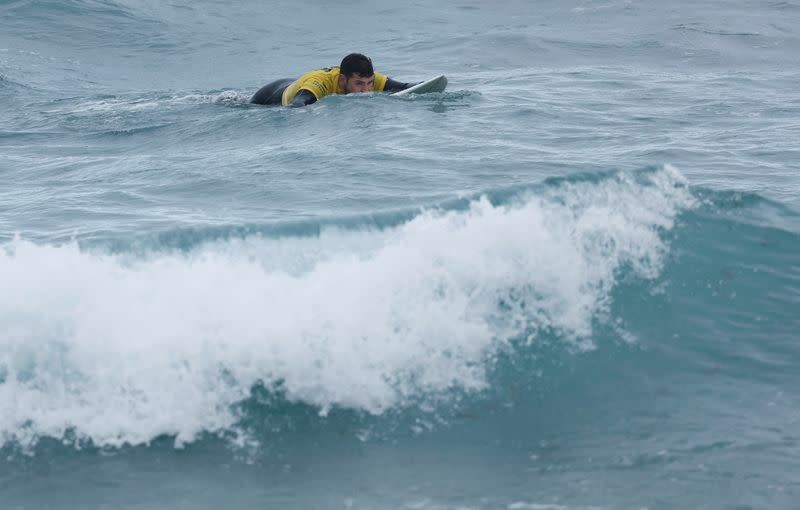 Surfer David Fernandez, who suffered an accident and left him having to use a wheelchair a year ago, surfs a wave during an adaptive surfing championship in Las Palmas de Gran Canaria