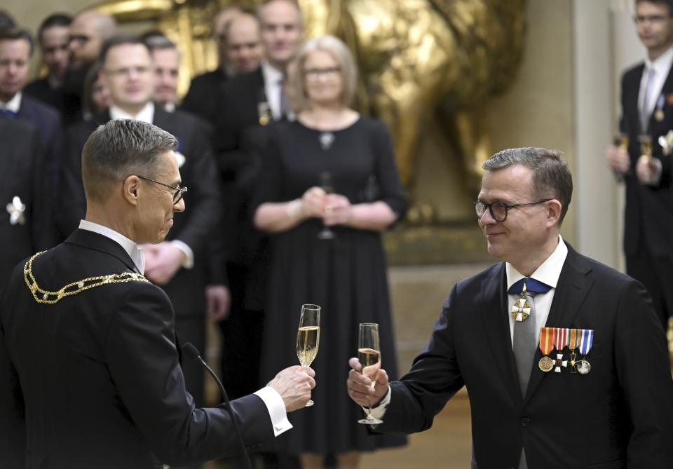 Finland's new President Alexander Stubb, left, toasts with Prime Minister Petteri Orpo during Stubb's inauguration ceremony at the Presidential Castle in Helsinki, Finland, Friday March 1, 2024. (Markku Ulander/Lehtikuva via AP)