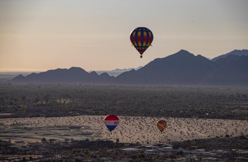 Hot air balloons make their way to a landing site in Palm Desert during the 8th annual Cathedral City Hot Air Balloon Festival on Friday.