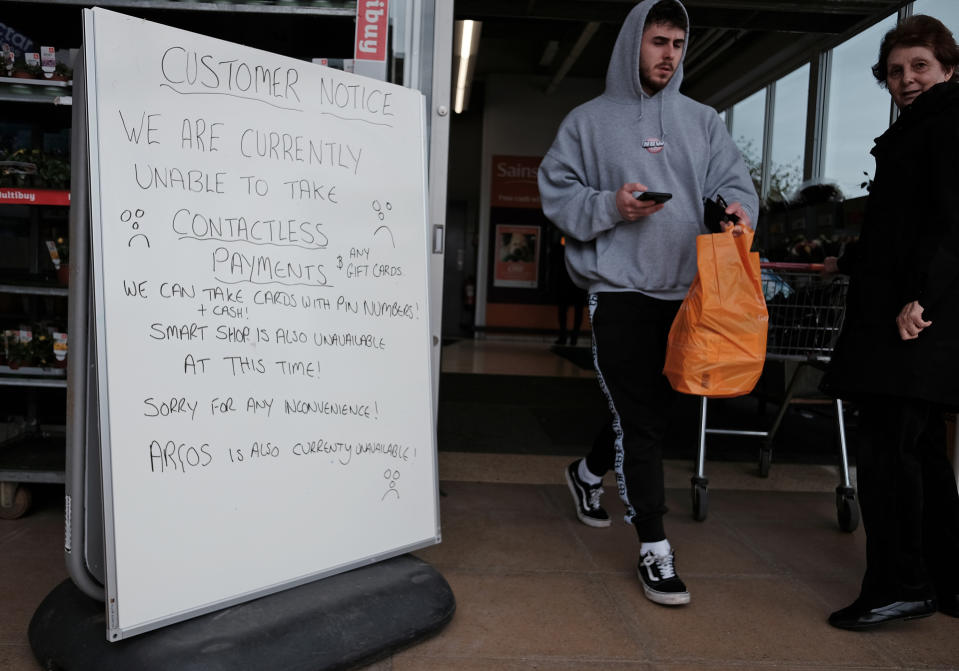 A handwritten sign outside a Sainsbury's store in Cobham informing customers of technical issues currently affecting the supermarket chain. Two of the UK's biggest supermarket chains, Tesco and Sainsbury's, were hit with technical issues on Saturday. Picture date: Saturday March 16, 2024. (Photo by Yui Mok/PA Images via Getty Images)