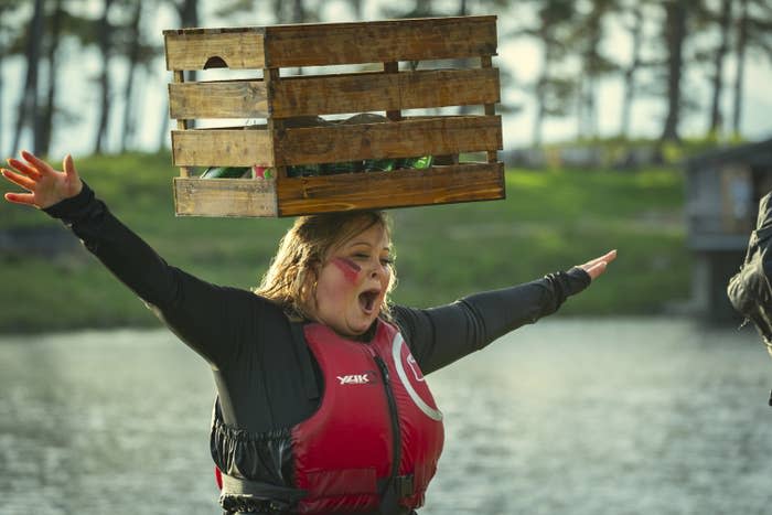 Rae from Snowflake Mountain balances a crate on her head