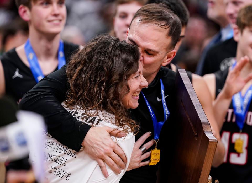 NorthWood Panthers head coach Aaron Wolfe hugs his wife on Saturday, March 25, 2023 at Gainbridge Fieldhouse in Indianapolis. The NorthWood Panthers lead at the half against the Guerin Catholic Golden Eagles, 66-63 in overtime for the IHSAA Class 3A state finals championship. 