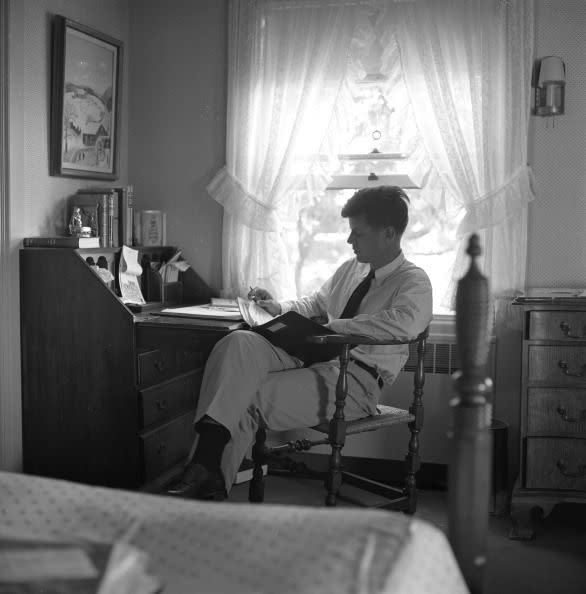 <p>JFK reads over documents at the desk in his bedroom. His parents' Hyannis Port home meant a lot to the powerful figure. "I always come back to the Cape and walk on the beach when I have a tough decision to make," <a href="http://kennedylegacytrail.com/take-the-tour/the-kennedys-and-cape-cod" rel="nofollow noopener" target="_blank" data-ylk="slk:he once said" class="link ">he once said</a>, "The Cape is the one place I can think and be alone."</p>