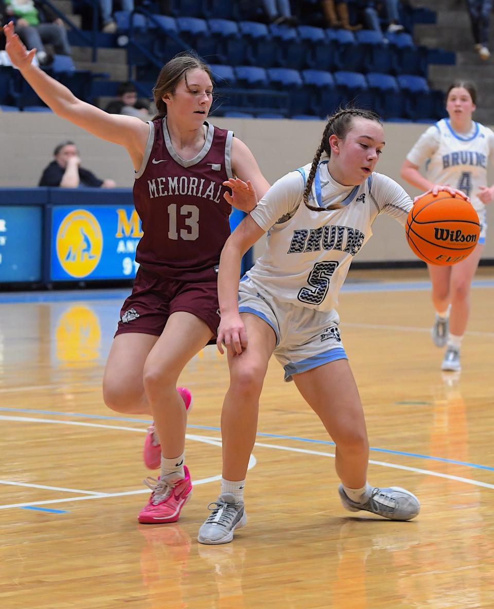 Bartlesville High School's Emma Zimmerman (5) keeps control of the ball during basketball action against Edmond Memorial in Bartlesville on Dec. 19, 2023. Basketball action will continue in the first week of January 2024.