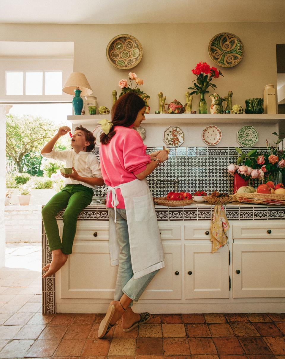 De Castellane and her son Vadim in the kitchen. Backsplash of vintage tile.