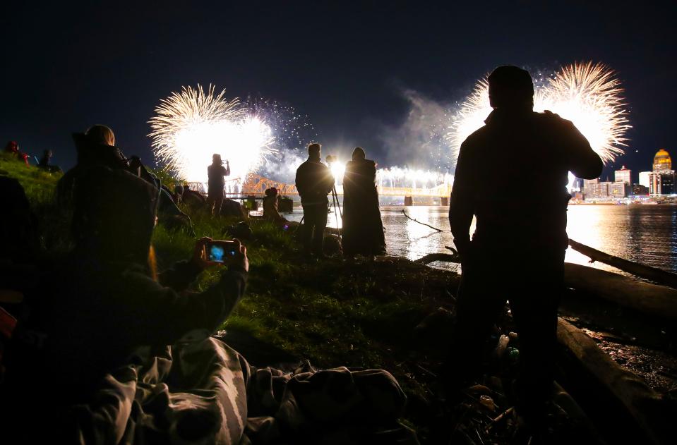 The finale of Thunder Over Louisville explodes for the Clark Memorial Bridge as people line the bank of the Ohio River in Clarksville to catch a view and video Saturday. April 20, 2024.