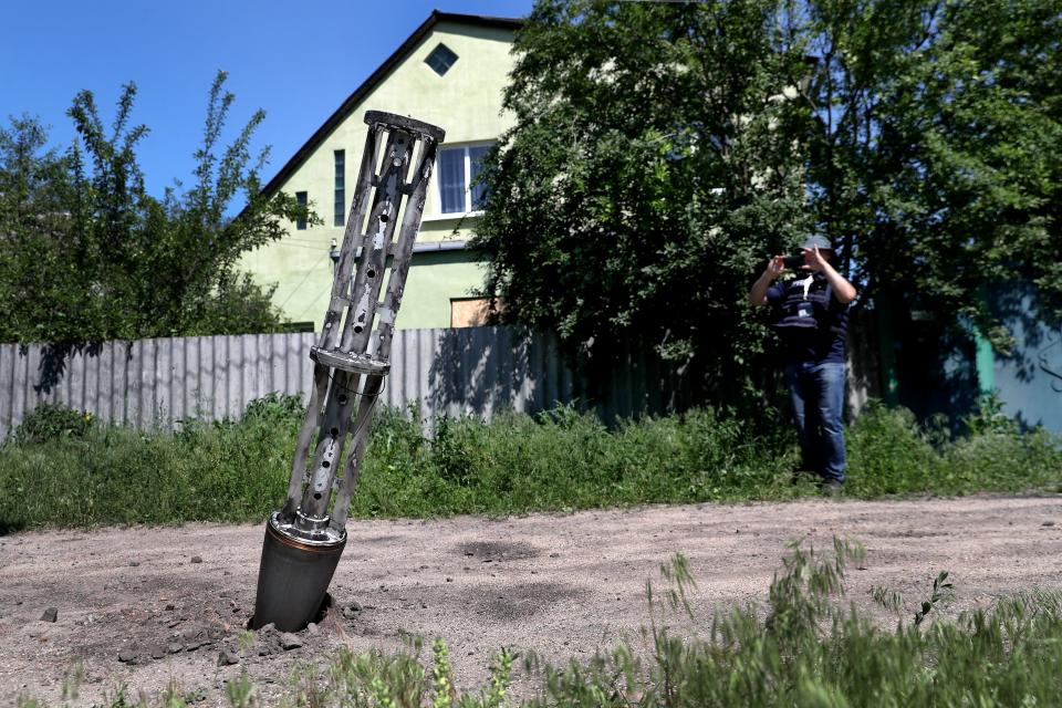 An emptied cluster munition container is seen stuck in the ground following a military strike, amid Russia's attack on Ukraine, on the outskirts of Kharkiv, Ukraine June 10, 2022. REUTERS/Ivan Alvarado