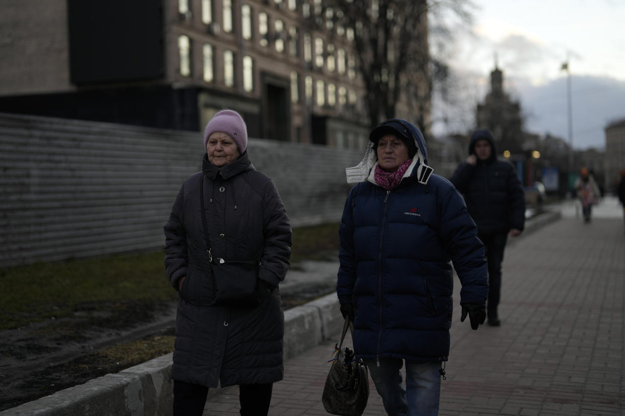 Women walk in central Kyiv, Ukraine, Tuesday, Feb. 21, 2023. (AP Photo/Thibault Camus)